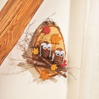Owls from cones on birch disc